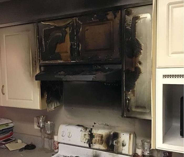 Stove with extensive fire damage and soot coverage