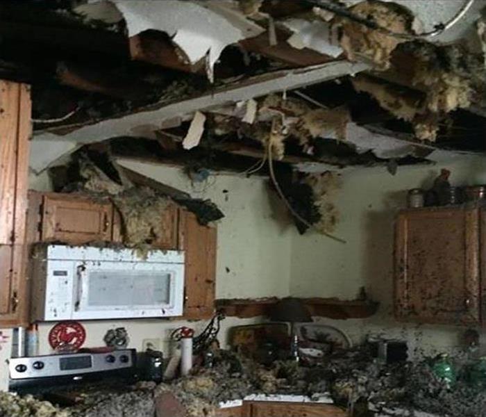 fire damaged kitchen with soot covering everything