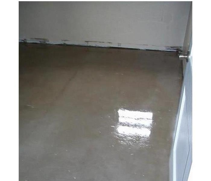 water pooling and covering the concrete floor in an empty garage