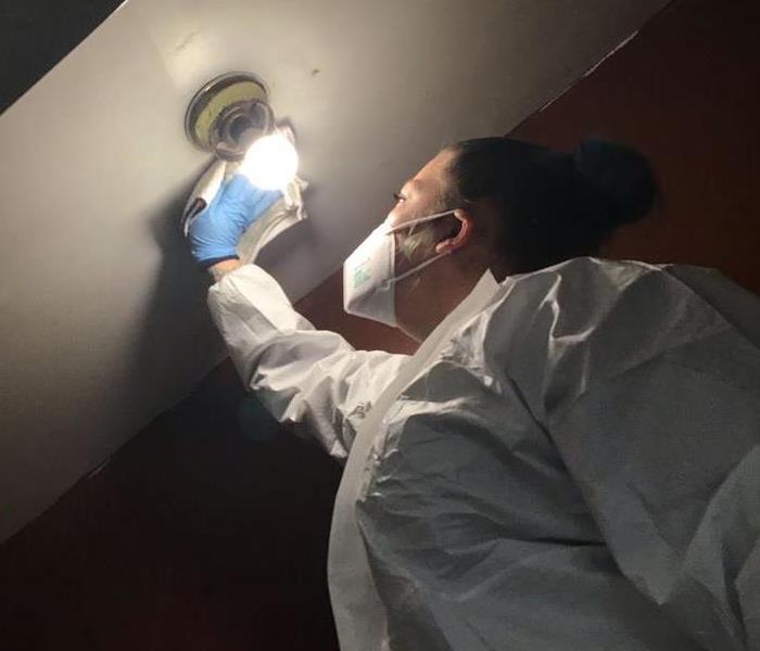 SERVPRO technician cleaning soot after a fire damage
